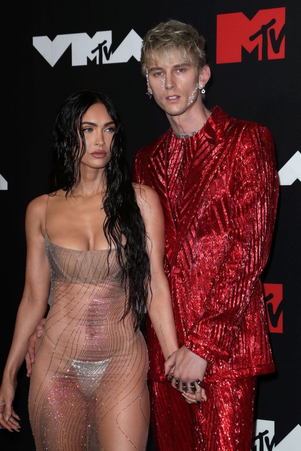 Megan Fox in a transparent dress with her boyfriend MGK on the red carpet of the 2021 MTV VMAs at Barclays Center in Brooklyn, New York on September 12th, 2021.