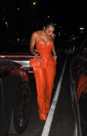 Draya Michele puts on a busty display as she steps out donning an orange ensemble to dinner with friends at TAO in Hollywood on October 14, 2021.