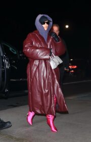 Kim Kardashian switches up her look with a leather coat and hoodie when she heads back to the hotel, after SNL rehearsals.