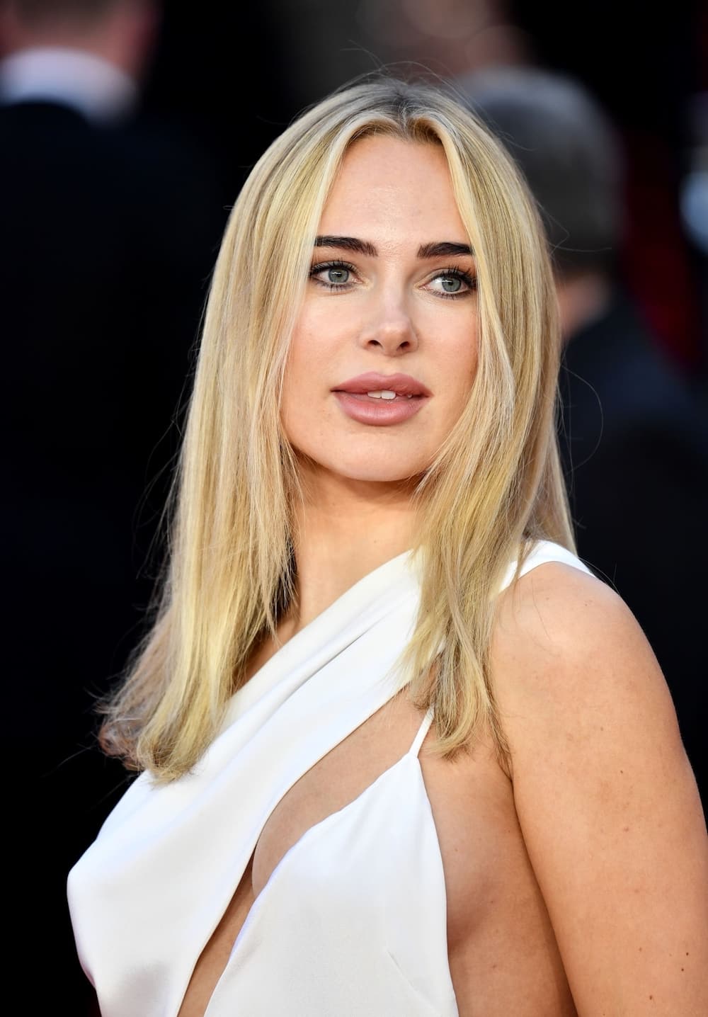 Kimberley Garner risked a wardrobe malfunction in a white cut-out gown on the red carpet for the ‘No Time To Die’ world premiere held at Royal Albert Hall, London on September 28, 2021.