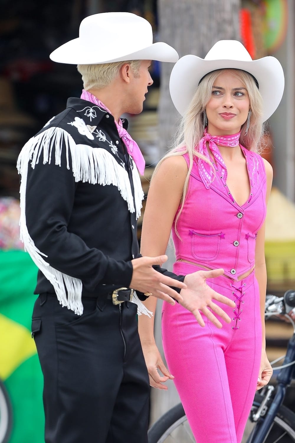 Margot Robbie and Ryan Gosling in cowboy hats on the set of Barbie movie.