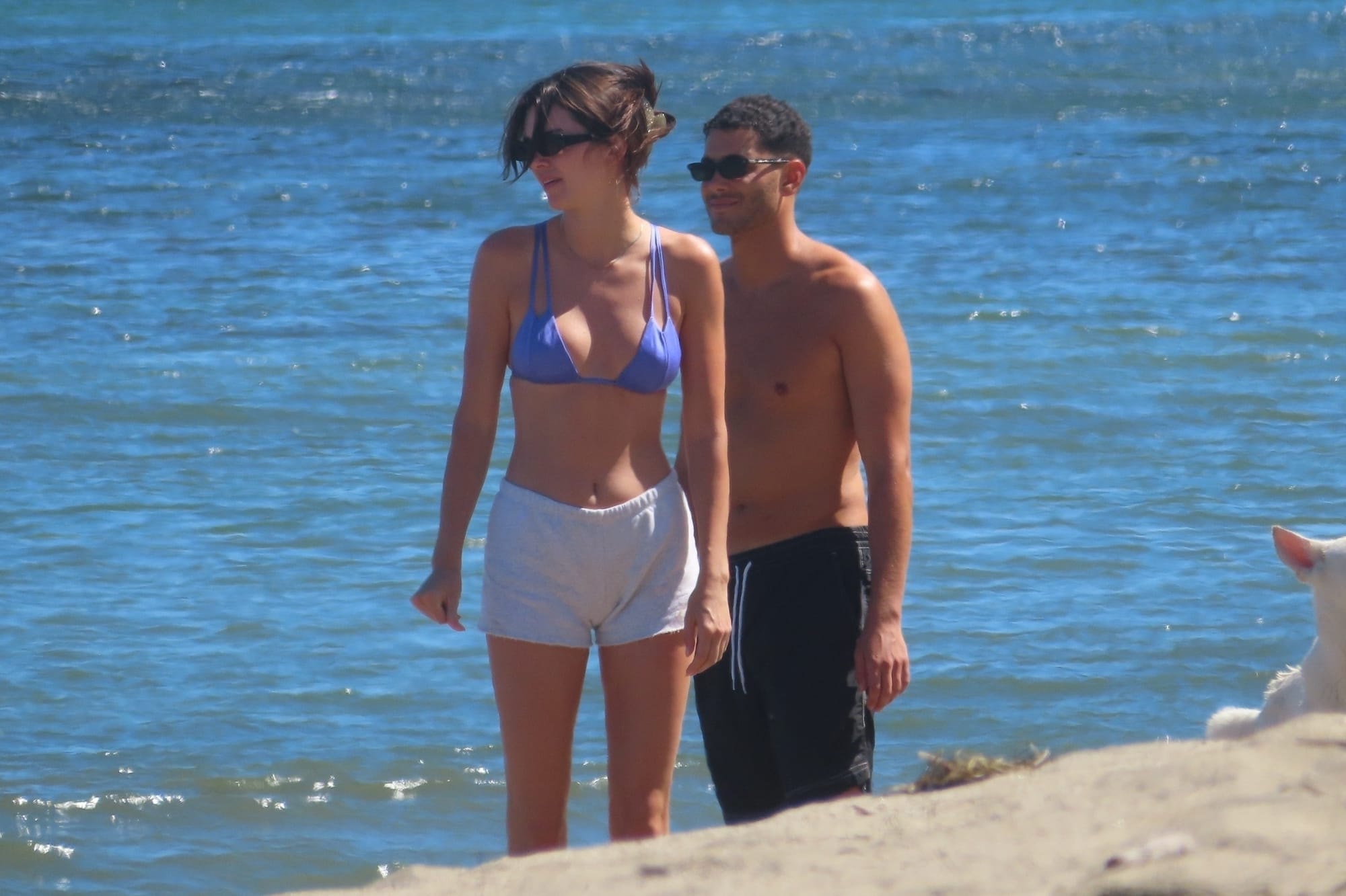 Kendall Jenner in a tiny blue bikini top with her shirtless friend Fai Khadra at the beach in Malibu on June 19, 2022.