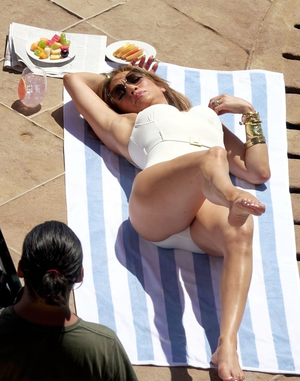 JLO in an one-piece white swimsuit.